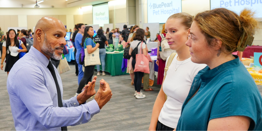 Dr. Satesh Bidaisee talking to students at SVM Career Fair 2025