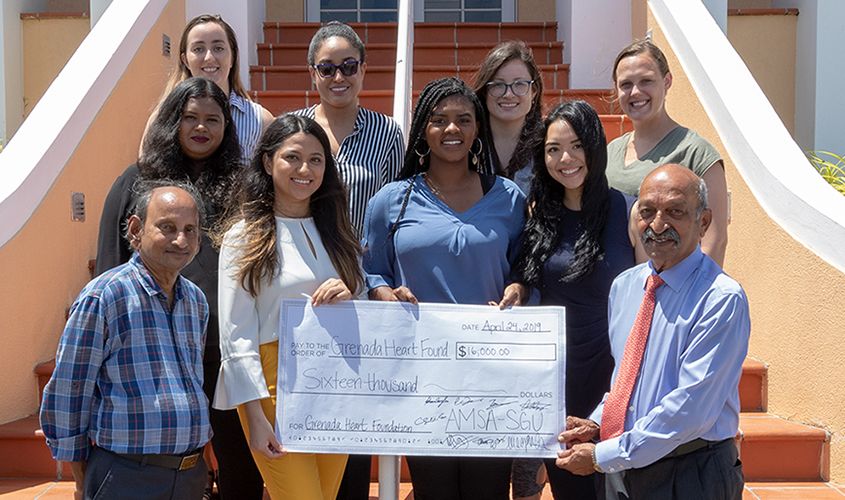 AMSA members presenting a donation for global health initiatives at SGU, supporting medical education and community health. News