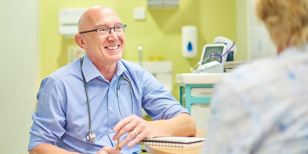 A family physician speaks with a family after a routine visit