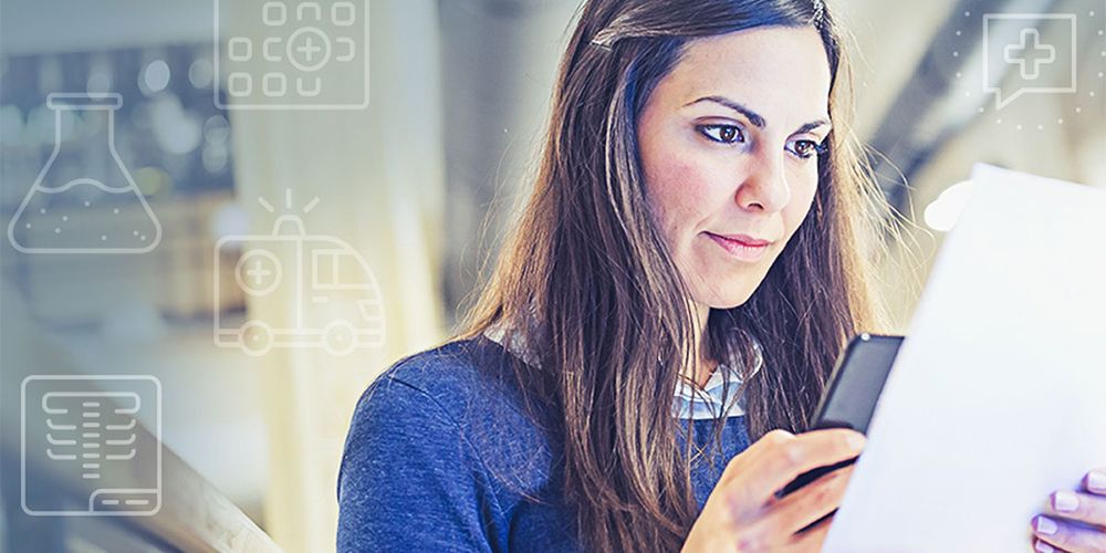 Woman studying for Step1 and holding a paper covered in colorful icons.