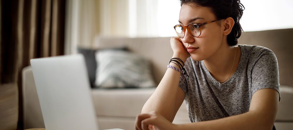 Close up of pre-med student on laptop preparing applications