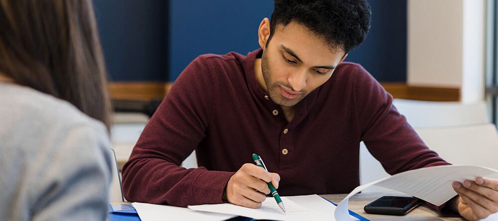 A college student diligently studies their academic coursework.