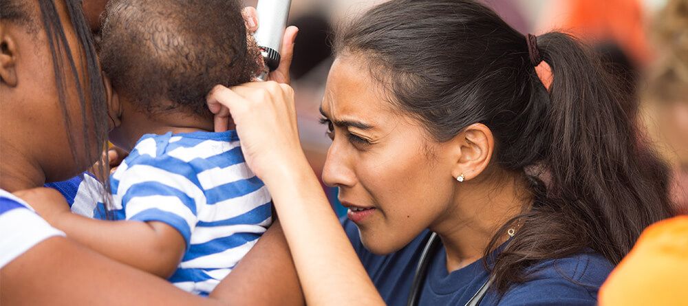 SGU Medical Student treating a baby