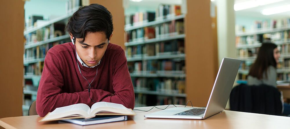Pre-med student studying in college library.
