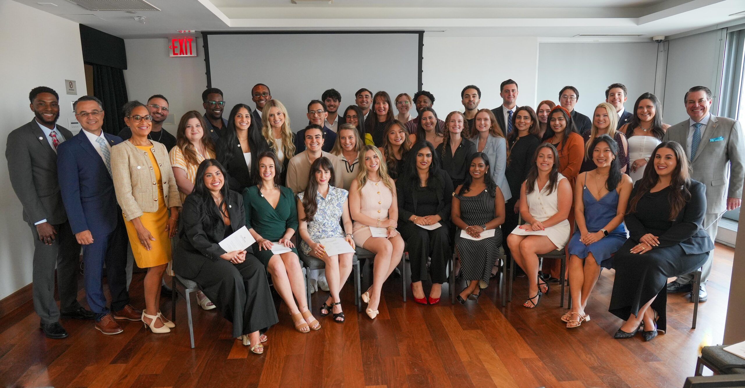 A group of SGU students and faculty attending a live oral research presentation in a university auditorium during Research Day. News