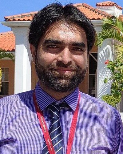 Firdous Ahmad Khan - Man in purple shirt with tie