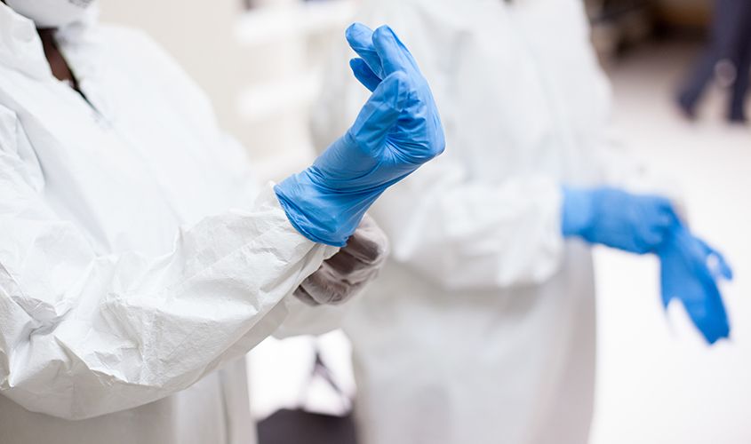 Surgeon or medical professional carefully donning sterile surgical gloves News