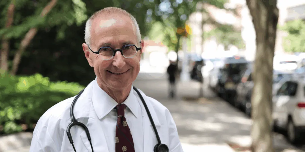 Dr. James Rucinski standing outside wearing a white lab coat