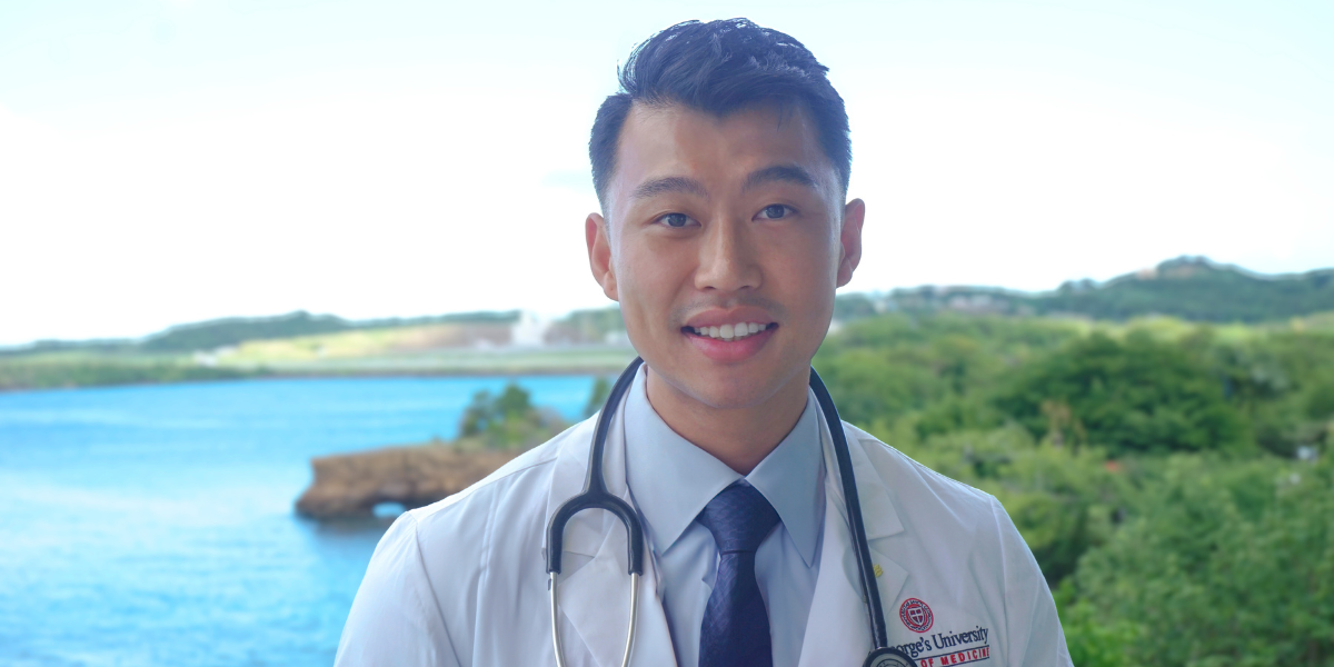 Jimmy Choy in Grenada standing in his white coat, a symbol of his bold career pivot to medicine