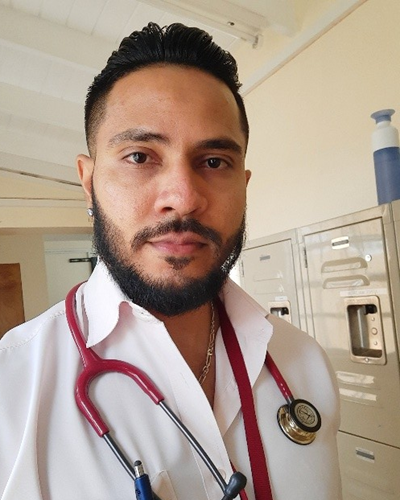 Narindra Roopnarine, St. George's University (SGU) graduate and scholarship recipient, posing in a professional setting.