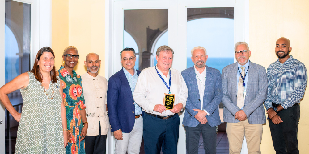 Dr. Calum Macpherson being awarded the One Health One Medicine Excellence Award at the SGU Research Day Prizing Giving Ceremony 2026