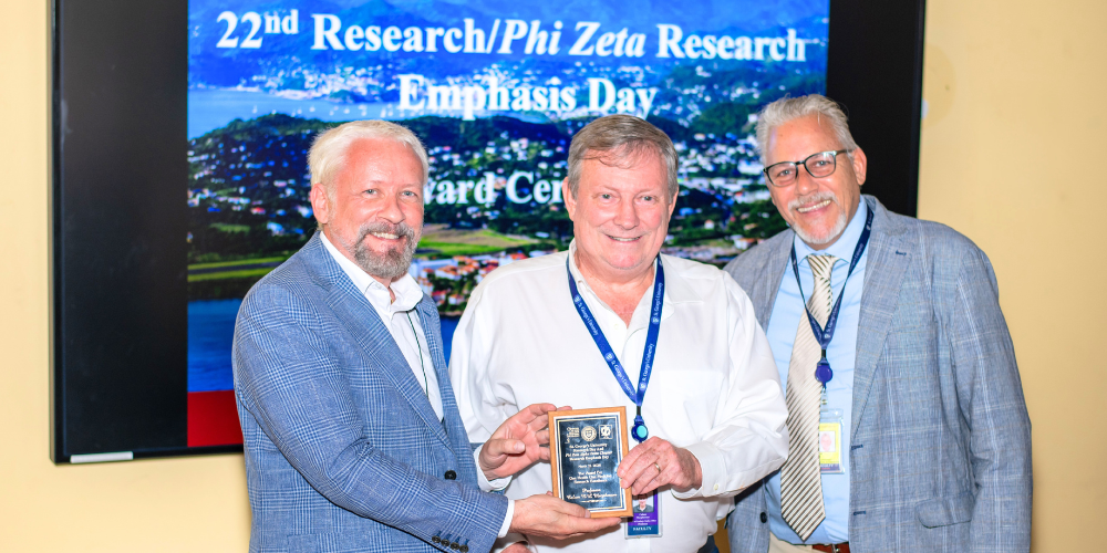 Dr. Calum Macpherson receiving the One Health One Medicine Excellence Award at the SGU Research Day Prizing Giving Ceremony 2026