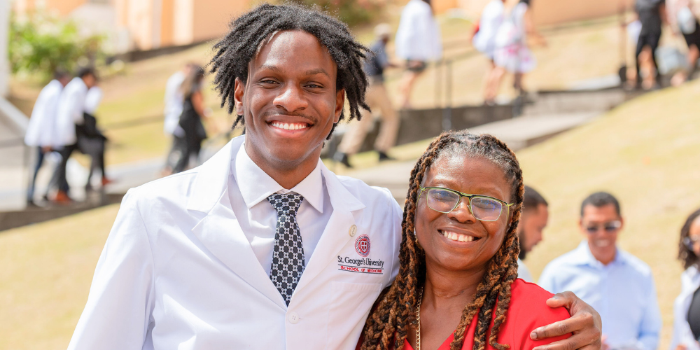 Term 1 SOM student, Derrick Bernard and his mom, Dr. Derria Cornwall-Bernard at Spring 2026 SOM White Coat Ceremony