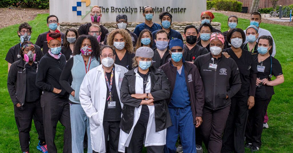 Group portrait of The Brooklyn Hospital Center (TBHC) team, including doctors, nurses, and staff