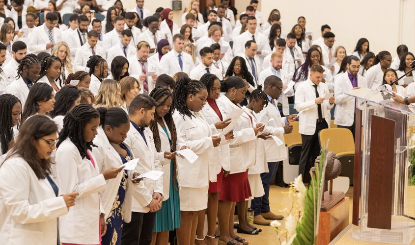After receiving their white coats, the ceremony ended with students and other physicians in the audience reciting the Oath of Professionalism—pledging to uphold the highest of ethical standards while treating their patients. 