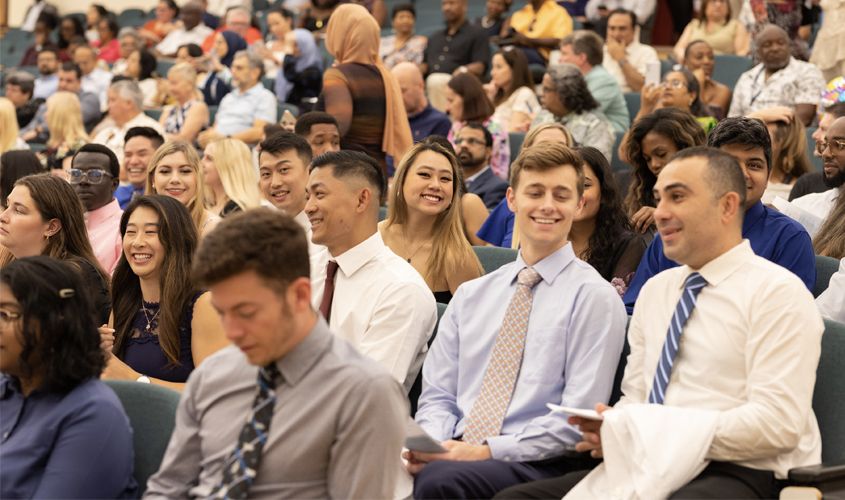 It was all smiles, as students eagerly awaited their name being called for their turn to walk across the stage and put on that white coat. 