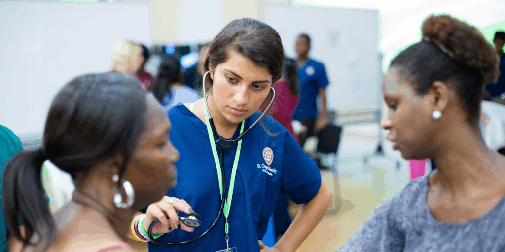 A medical student observes how to listen to a patient's lungs, a skill necessary when learning how to become a pulmonologist