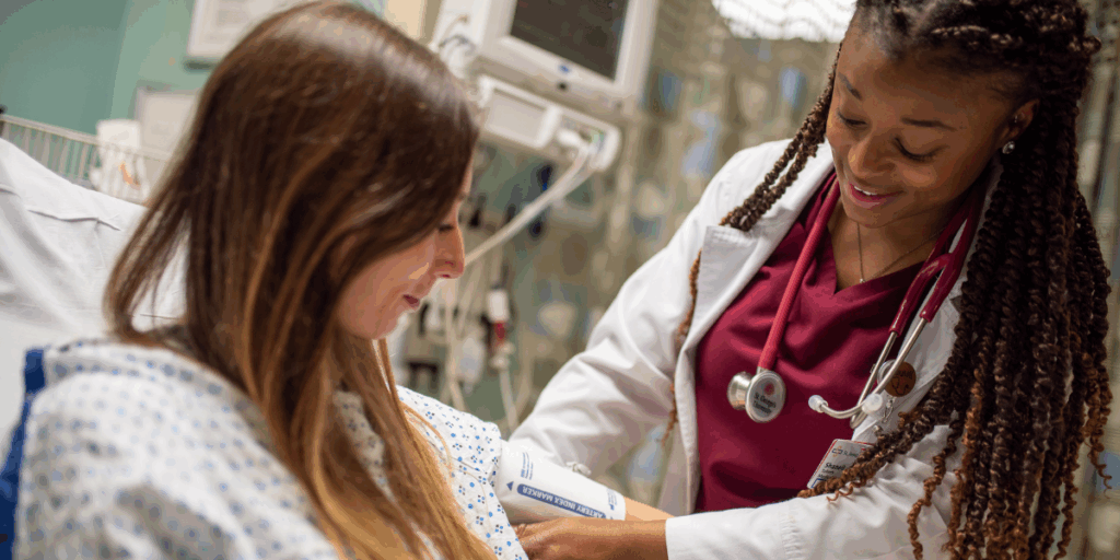 A med student taking a patient's blood pressure, an important skill learned at all clinical sites including SGU UK clinical rotations