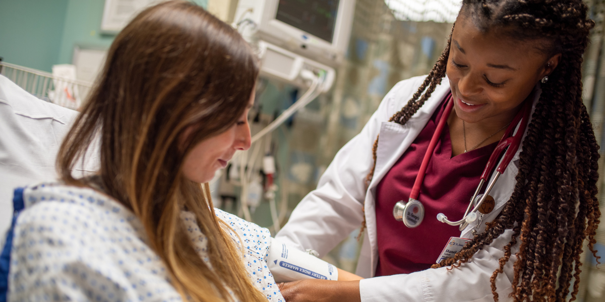 A med student taking a patient's blood pressure, an important skill learned at all clinical sites including SGU UK clinical rotations
