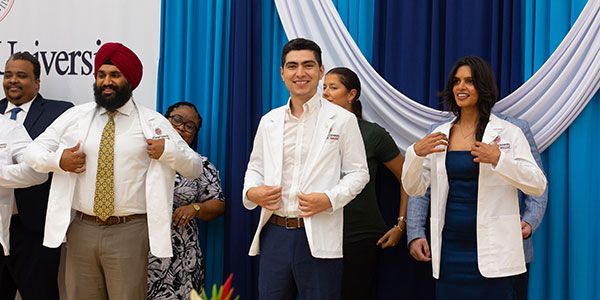 SGU Students receiving white coats