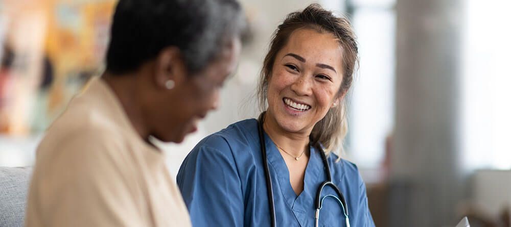 Medical provider laughing alongside a patient