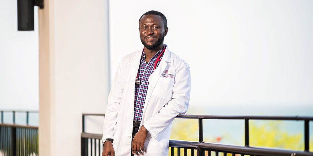 Enoch Anane, MD '24, Ghana, in white coat 