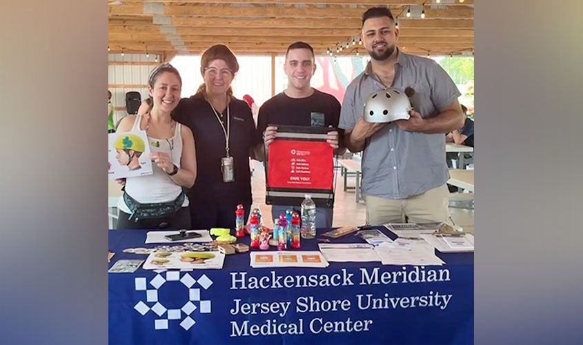 SGU medical students smile at their community service booth during a Jersey Shore outreach event. News