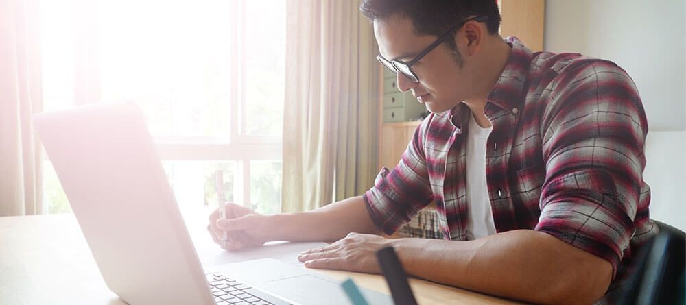 Pre-med student preparing application materials at desk