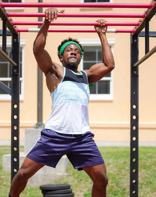 Student using monkey bars outdoors on the St. George’s University Grenada campus.