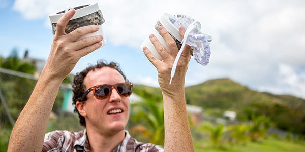 Student in a field with study samples