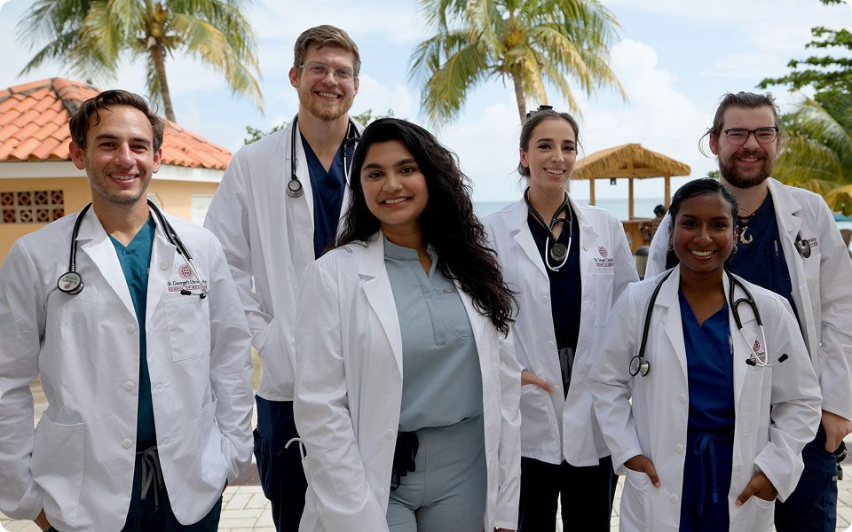 SGU students in their white coats