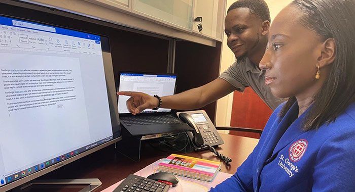 SGU students collaborating on a paper