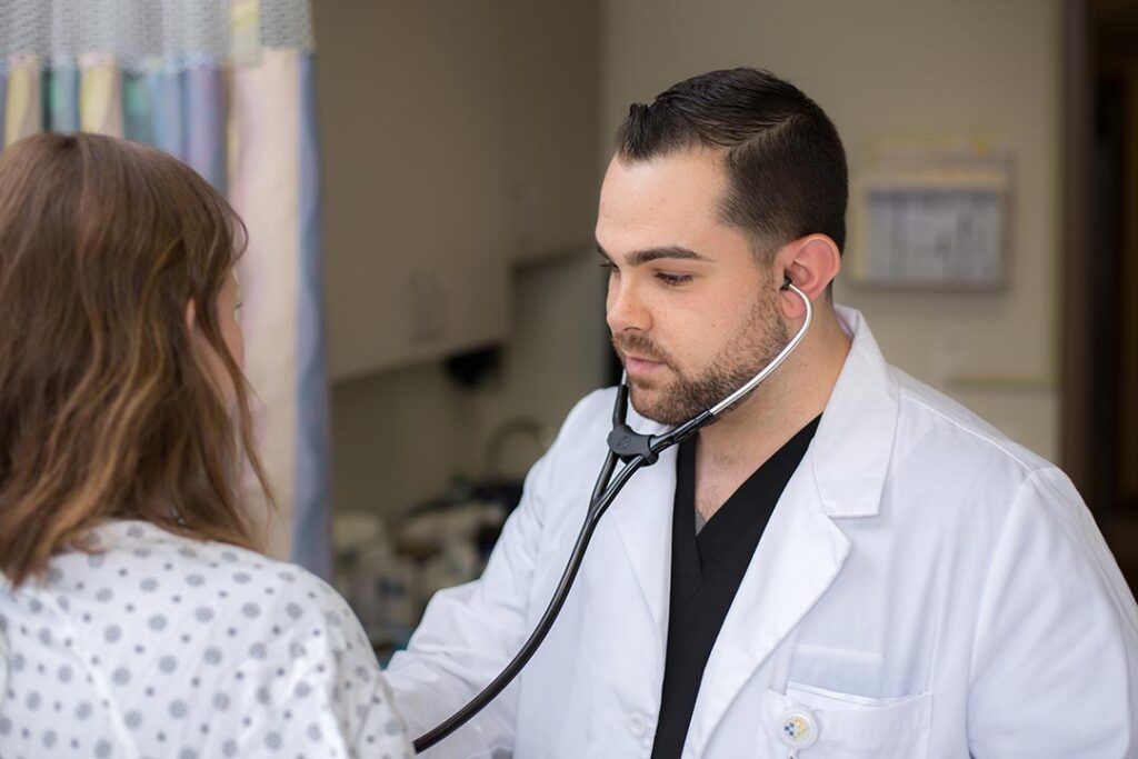 Medical student in clinical training wearing a stethoscope at St. George’s University.