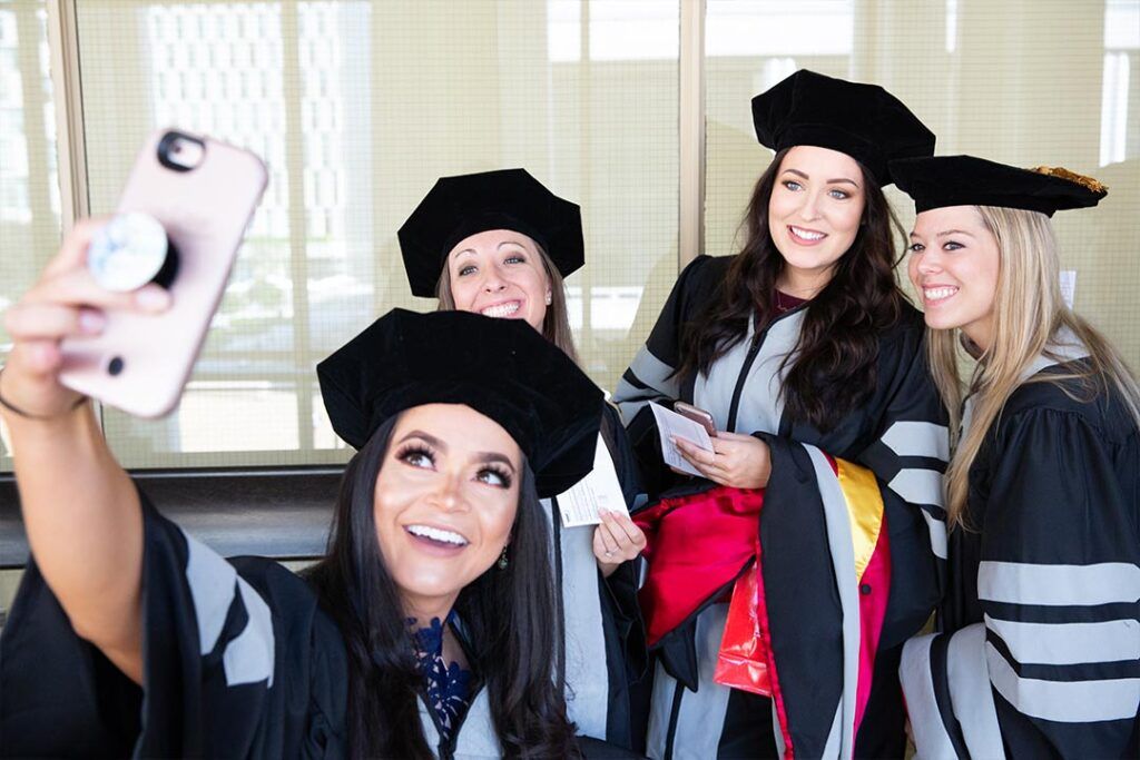 SGU School of Veterinary Medicine graduates in caps and gowns celebrating at commencement.