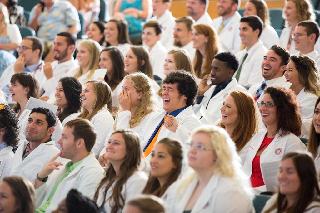 SGU veterinary medicine student receiving white coat during ceremony at St. George’s University.